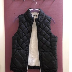 Black fur-lined zip up vest.